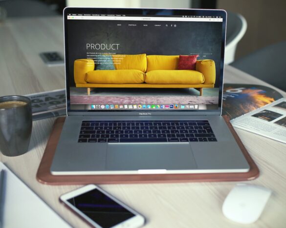 turned on MacBook Pro beside gray mug